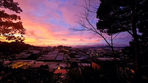 a view of a city with a sunset in the background at Balabum home and more in Trai Mat