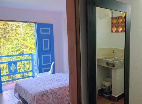 a bedroom with a bed and a sink and a window at Apartahotel Villa Carolina 3 in Jericó