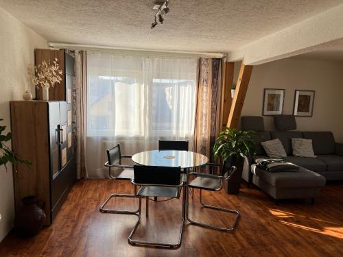 a living room with a table and chairs and a couch at Schlössleblick in Wehr