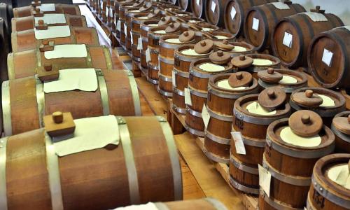 a bunch of wine barrels lined up in a row at Central Park Hotel Modena in Modena