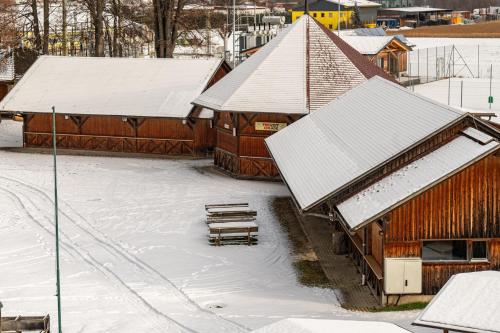 a group of buildings with snow covered roofs at Raddörfl in Teufenbach