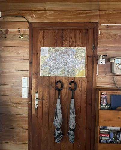 a door with a map and shoes hanging on it at Chalet im Gus - Flumserberge & Walensee in Oberterzen