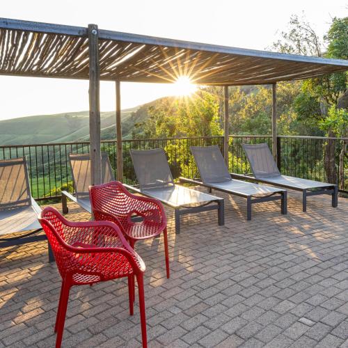 a group of chairs and tables on a patio at Cavern Resort & Spa in Bergville