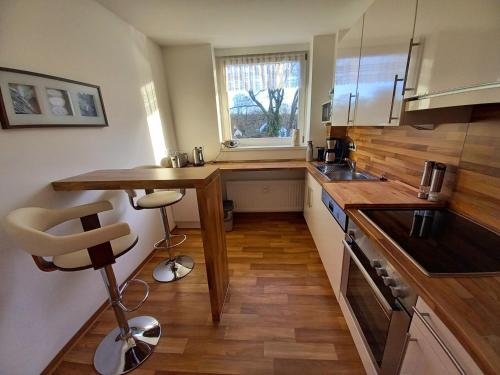 a small kitchen with a counter and a window at Ferienwohnung Sonne und Meer in Ulstrupfeld