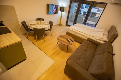 a living room with a couch and a table at Central Suite in Trebinje