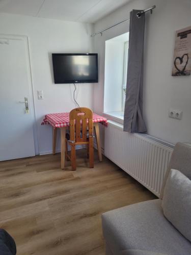 a living room with a table and a chair at Ferienhaus Gertrud in Nesselwängle