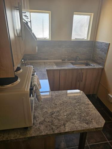 a kitchen with a sink and a counter top at MATSOP Guesthouse in Bela-Bela