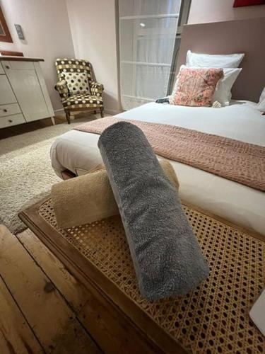 a bedroom with a bed with a towel on it at Gîte Orget in Saint-Macaire
