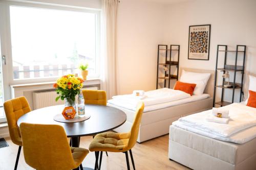 a small living room with a table and a couch at Platz für 8 Pers - C4S Come4Stay Monteure "InnArt" Boxspringbett Einzelbett Töging am Inn, Parkplatz, WLAN, Balkon, Smart TV, voll ausgestatteter Küche, Waschmaschine in Töging am Inn