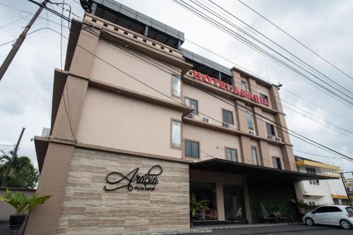 a building with a sign on the side of it at A'rabia Style Wahid Hasyim in Medan