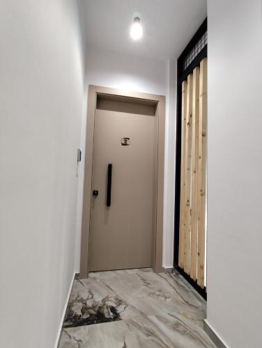 a corridor with a door in a room at Meteora Gold and Glass Suites in Kalabaka