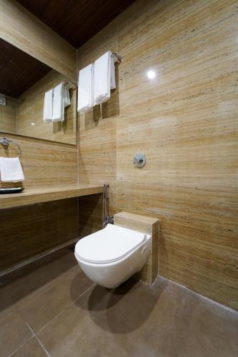 a bathroom with a white toilet in a room at Hotel Bright Star in Mahabaleshwar