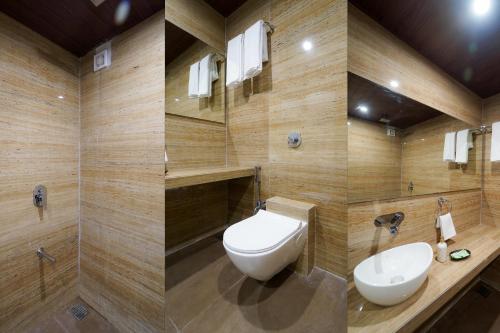 a bathroom with a toilet and a sink at Hotel Bright Star in Mahabaleshwar