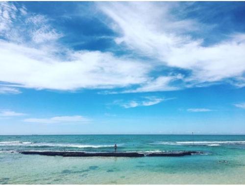 a person is standing on a small island in the ocean at Green Grove in Matara