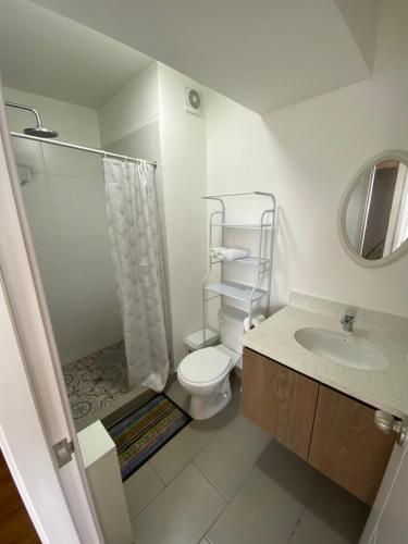 a bathroom with a toilet and a shower and a sink at Vista piso 24 in Lima