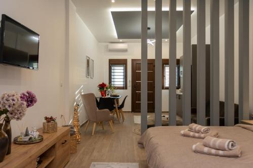 a bedroom with a bed and a dining room at Celestia House in Kalabaka