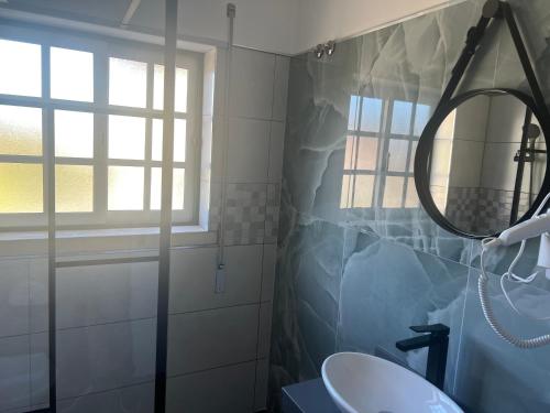 a bathroom with a sink and a mirror at White Guest in Fátima