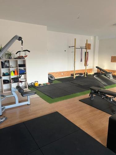 a gym with several exercise equipment in a room at Casa Saudade luxury rooms in Faro