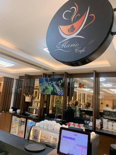 a coffee shop with a laptop on a counter at Imperial Plaza Hotel, Juba in Juba