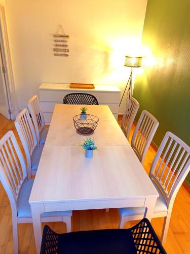 a white dining room table with chairs and a lamp at Excalibur - 4 Chambres - Puydufou - proche gare in Cholet