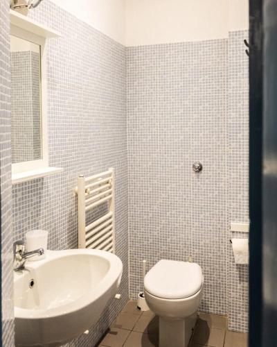 a bathroom with a white toilet and a sink at Michelangelo's Relais in Florence