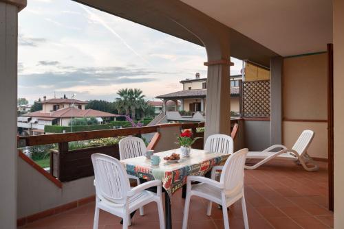 a patio with a table and chairs on a balcony at Follonica Apartments - Pool & Relax in Follonica