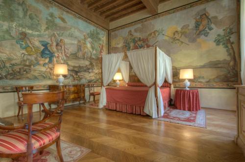 a bedroom with a bed and a painting on the wall at Palazzo Niccolini al Duomo Residenza D'Epoca in Florence