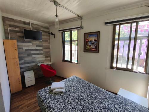 Ένα ή περισσότερα κρεβάτια σε δωμάτιο στο Hostal del Viajero