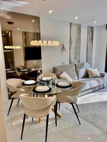 a living room with a couch and a table and chairs at Adeje Paradise in Adeje