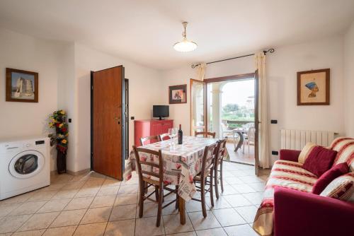 a living room with a table and a couch at Follonica Apartments - Pool & Relax in Follonica