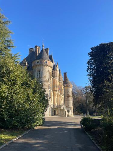 an old castle sitting in the middle of a road at Tranquil Watermill in Pré-en-Pail