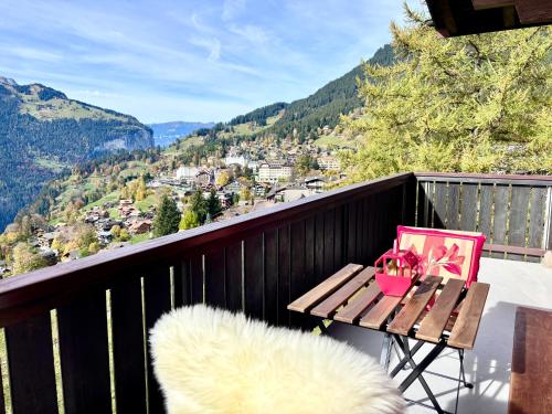a balcony with a table and a view of the mountains at Jungfraujoch, Chalet Ski In&Out, Wengen, Valley view in Wengen