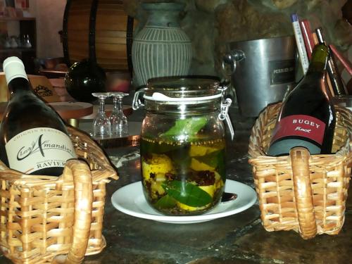 two bottles of wine and a jar of pickles at Le Relais Des Vieilles Postes in Les Avenières