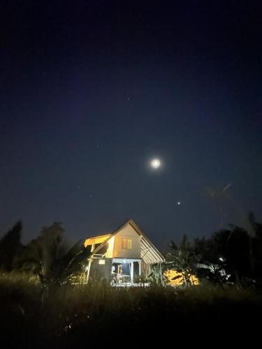 a house at night with the moon in the sky at Royal mountain view (วิวเขาหลวง) in Ratchaburi