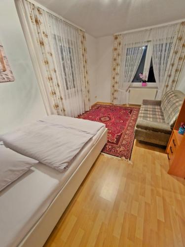 a small bedroom with a bed and a couch at Alfeld City Apartment in Alfeld