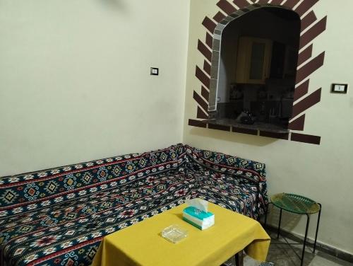 a couch in a room with a table and a mirror at Aswan Nile view house in Aswan