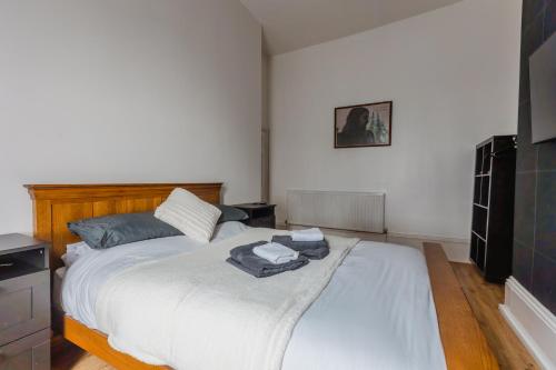 a bedroom with a large bed with white sheets at Hullidays City Centre Urban Apartment 2 in Hull