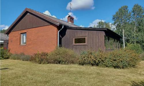 a brown building with a chimney on top of it at Villa Skogsstigen in Hallsberg