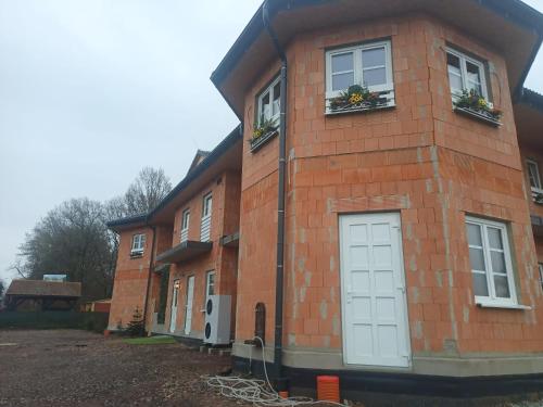 a brick house with white doors and windows at Penzion mezi zámky in Kostelec nad Orlicí