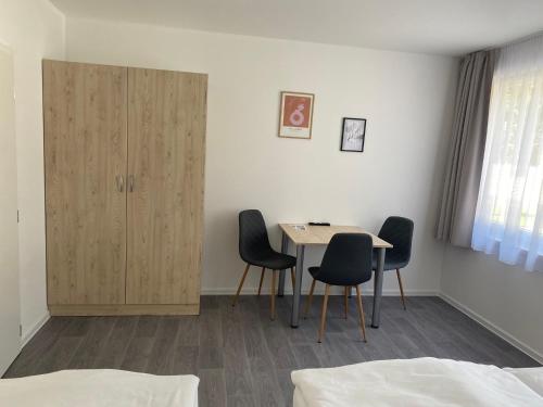 a room with a table and chairs and a cabinet at Rodinné chatky Kraskov in Chrudim