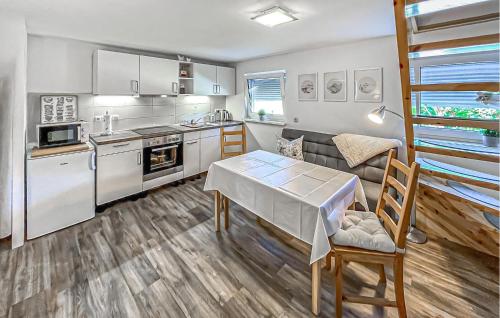 a kitchen with a table and a dining room at Ferienhaus Buddenhagen in Buddenhagen