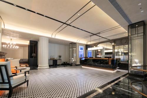 a living room with a couch and a fireplace at Madison Hotel Wuhan Jianghan Road Pedestrian Street in Wuhan