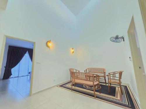 a dining room with two chairs and a table at SD Home in Rawang in Batu Arang