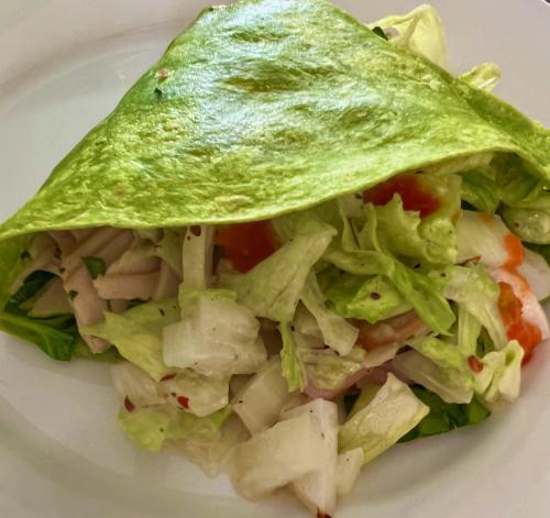 a salad with lettuce and tomatoes on a white plate at Kaanapali's Royal Luxury Plantation Beach & Golf Retreat in Kaanapali