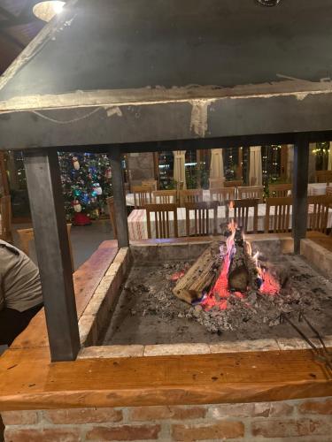 a fire pit with meat cooking in it at VILA DISHA in Tirana