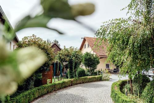 a cobblestone street in front of a house at Stadler Hof in Großgundertshausen