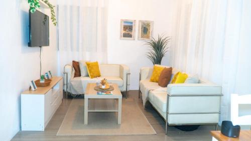 a living room with two couches and a coffee table at Estrella de Mar in Pedernales