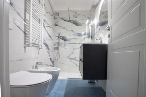 a bathroom with a toilet and a sink at Appia - Regina Viarum B&B in Rome