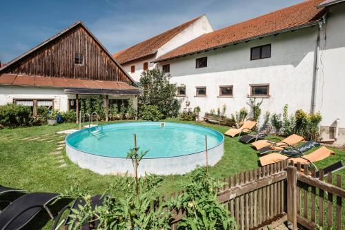 a swimming pool in the yard of a house at Stadler Hof in Großgundertshausen