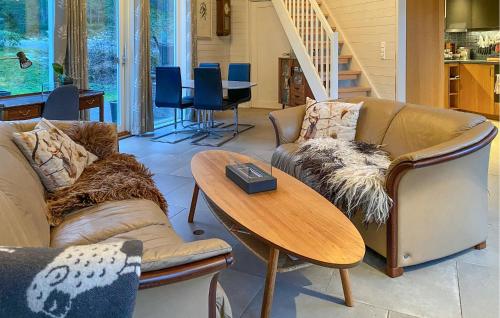 a living room with two couches and a table at Beautiful Home In Skodje in Vatne